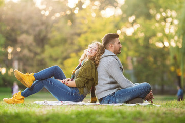 Fototapeta premium Young couple in park posing in front of a camera
