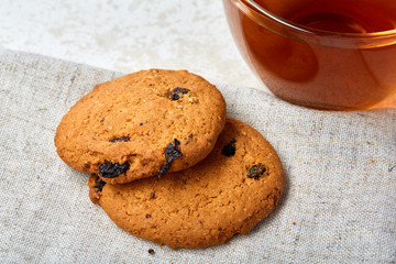 Top view close up picture of glass teacup with biscuits isolated on white background, frontfocus, shallow depth of field