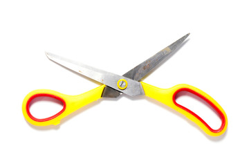 Metal scissors with yellow and red plastic holder on white background