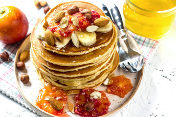 Breakfast oatmeal pancakes with banana, walnuts and honey