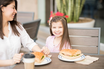 Cute little girl at cafe with her mother