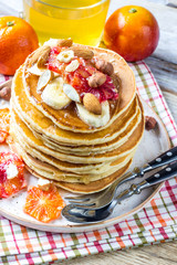 Breakfast oatmeal pancakes with banana, walnuts and honey