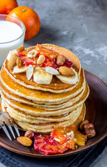 Breakfast oatmeal pancakes with banana, walnuts and honey