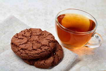 Top view close up picture of glass teacup with biscuits isolated on white background, frontfocus, shallow depth of field