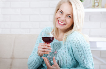 Closeup portrait of female customer drinking red wine with eyes closed.