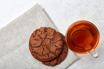 Top view close up picture of glass teacup with biscuits isolated on white background, frontfocus, shallow depth of field