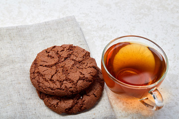 Top view close up picture of glass teacup with biscuits isolated on white background, frontfocus, shallow depth of field