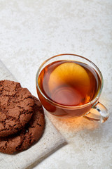 Top view close up picture of glass teacup with biscuits isolated on white background, frontfocus, shallow depth of field
