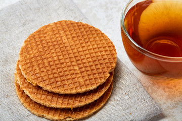 Top view close up picture of glass teacup with waffles isolated on white background, shallow depth of field