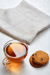 Top view close up picture of glass teacup with biscuits isolated on white background, frontfocus, shallow depth of field