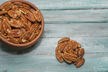 Pecan nuts on wooden background. Healthy food