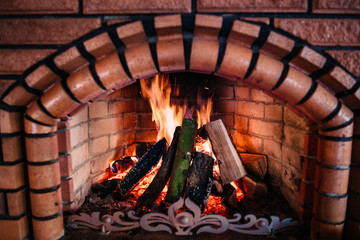 cozy flaming fire in a stone fireplace with red lights