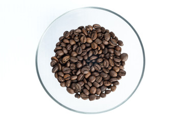 Roasted coffee beans on a glass transparent plate, isolated on white background.