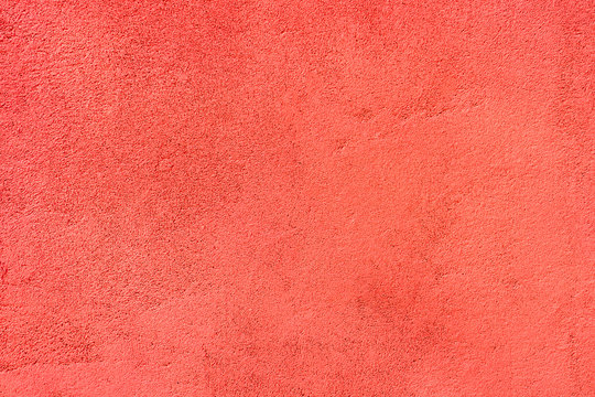 Red painted texrured wall.