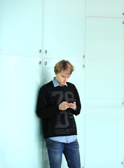 Lifestyle portrait of young man using a smart phone outdoors © lado2016