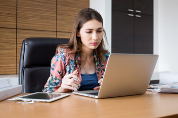 Woman used notebook for her work in the office.