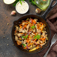 Warm salad with boiled meats and grilled vegetables (eggplant, carrots, paprika) on dark stone or slate background. Proper nutrition. Healthy lifestyle. Top view.