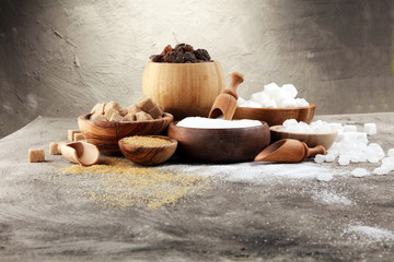 Various types of sugar, brown sugar and white on table