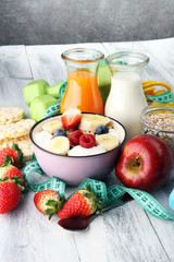 muesli with dairy and fruit, healthy lifestyle. bowl of cereal, fruit and dumbbell