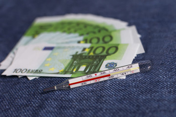the thermometer on the background of money, to be sick is expensive