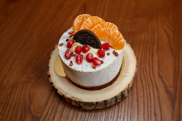 mousseous round dessert on a stand on a wooden table