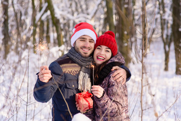 Happy couple posing with red hats, bengals at winter park