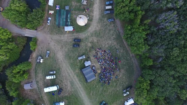 Aerial of out door concert or fireside people in camp chairs.