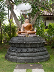 Statue of the Buddha god in the Buddhist temple Brahma Vihara Arama with statues of the gods on...