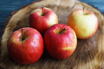 Four delicious ripe juicy red apples close up