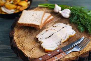 Ukrainian traditional snack, smoked salo or bacon with bread and greenery, tasty countryside meals.