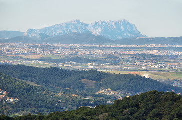 Montserrat multi-peaked mountain at background and towns in the surrounding area