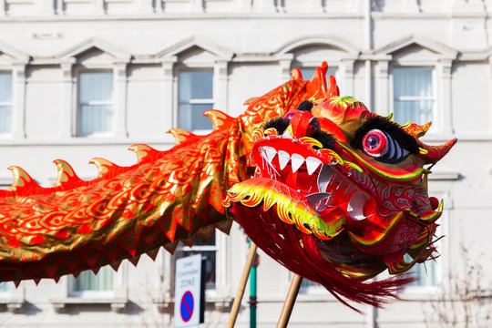 Up close with the vivid orange coloured dragon as it dances through the streets of Liverpool's Chinatown district during the new year celebrations.