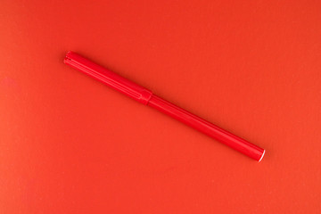 Red felt-tip pen on a red background.