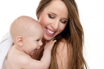 Happy mother hugging her adorable baby son. Happy family. Mother and newborn child portrait isolated on white background.