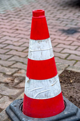 A Red white cone to warn the traffic