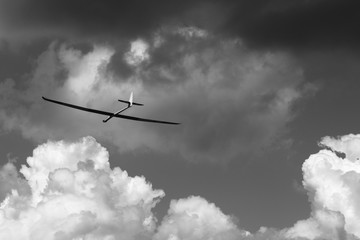 B&W RC glider in clouds - obrazy, fototapety, plakaty