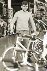 man standing with sport bicycle