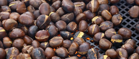 chestnuts roasted in big pan on the fire