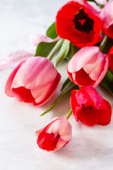 Bunch of spring tulip flower on a stone or slate background, selective focus.