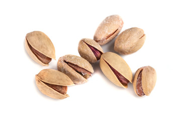 Heap of salted pistachio nuts isolated on a white background
