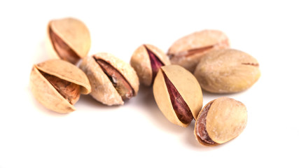Heap of salted pistachio nuts isolated on a white background