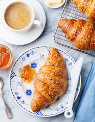 Croissant with coffee, jam and butter. Continental breakfast concept. Top view
