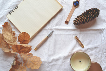 Opened sketchbook with pen and elements of decorarion. Minimalistic scandinavian flat lay. 