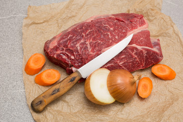 steak fat beef  with white plate and old wooden board