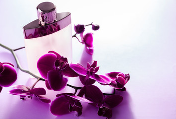 Obraz na płótnie Canvas Bottle of perfume with orchid