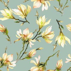 Yellow magnolia flowers on a twig on light green background. Seamless pattern. Watercolor painting.