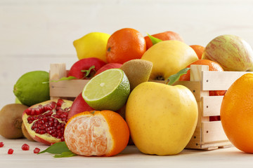Sliced fruits and whole fruit in a wooden box