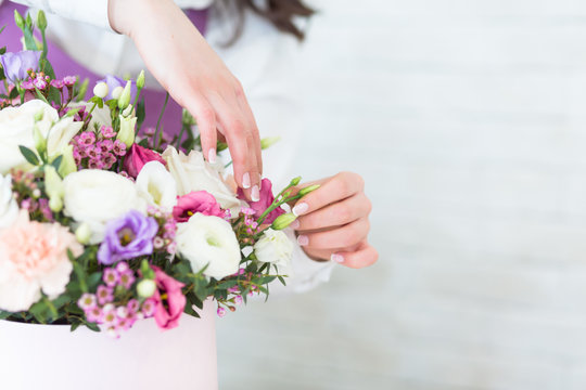 Woman florist making a beautiful flower composition in a flower shop