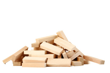 Heap of wooden blocks tower game isolated on white