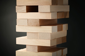 Wooden block tower game on black background